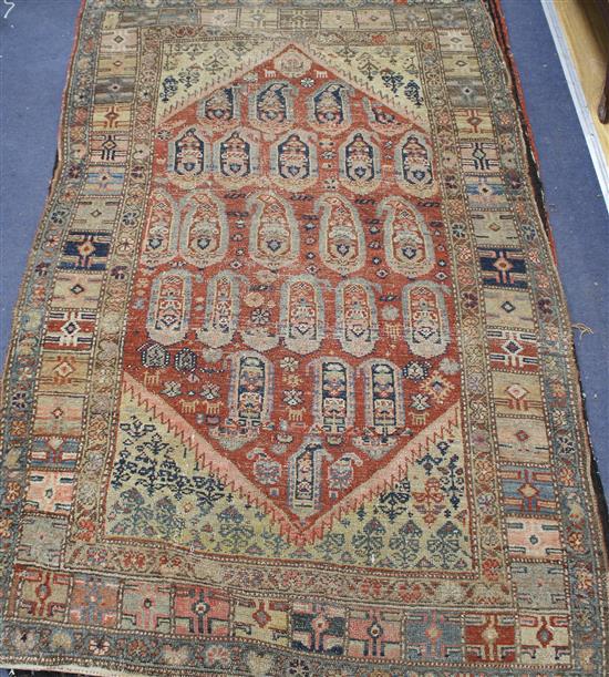 An Antique Persian red ground rug, with central medallion of boteh motifs, multi-bordered, 162 x 99cm